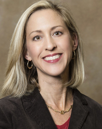 A woman in a black jacket and red shirt underneath