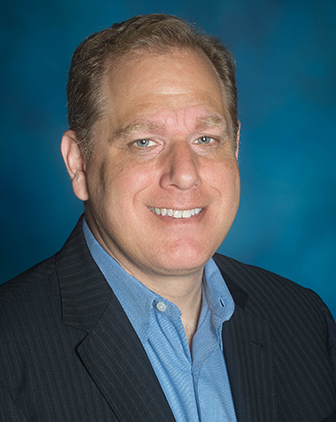 A man in a striped jacket and blue shirt