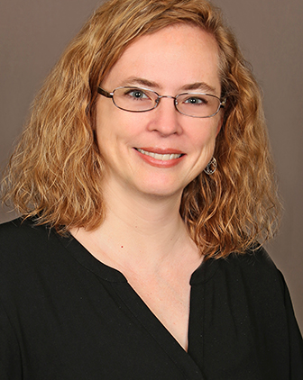  a woman with glasses and a black top