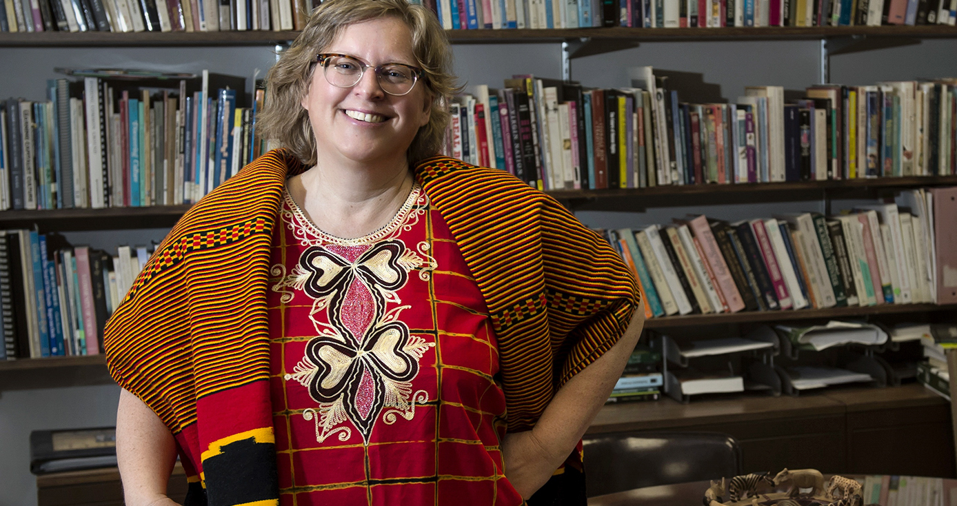 Porter in a brightly colored red blouse and scarf