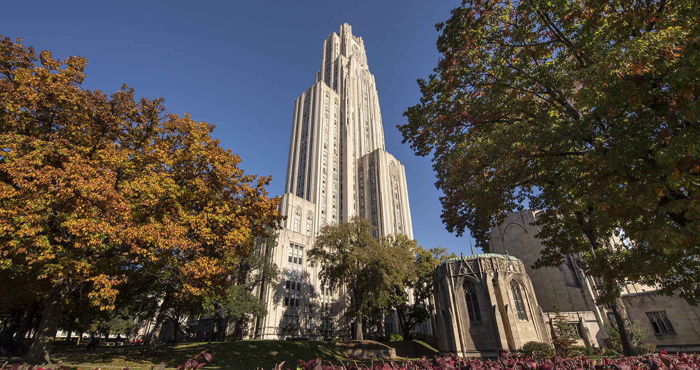 The Cathedral of Learning framed by trees in the fall