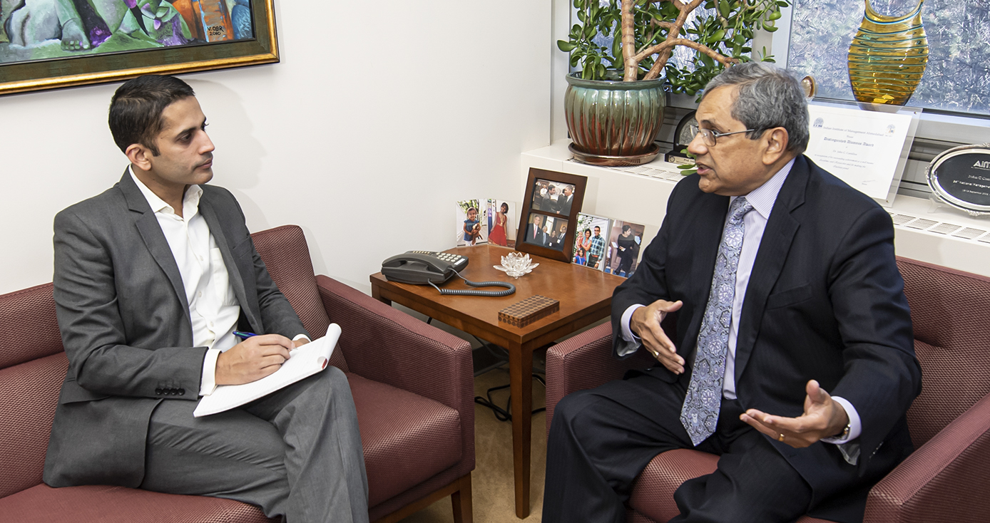 MBA student Kumar Vijayendra, left, talks with his mentor John Camillus