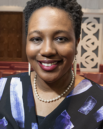 Yolanda Covington-Ward in a blue and black dress