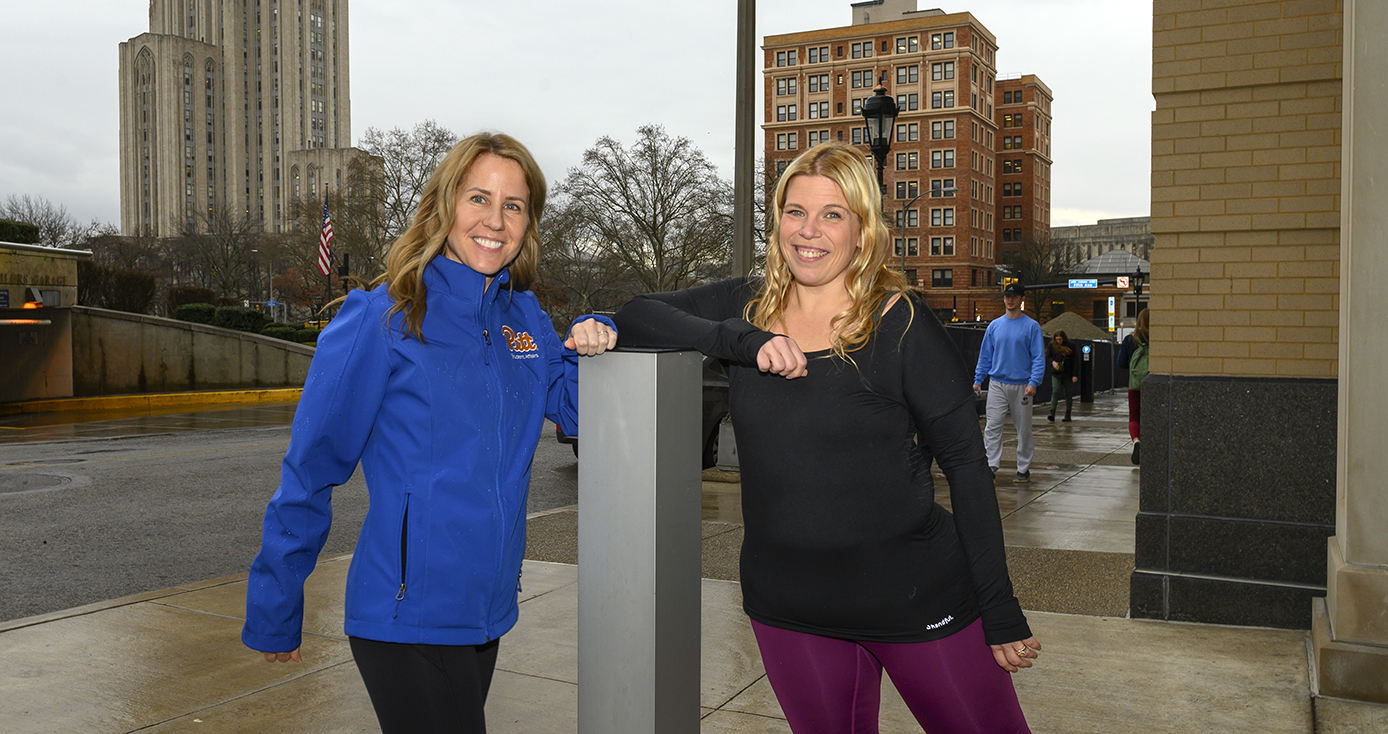 two women in running gear outside Nordenberg Hall