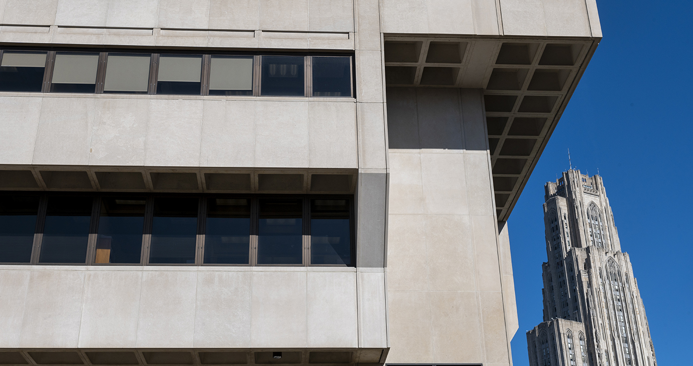 The side of a building, with the Cathedral of Learning in the background
