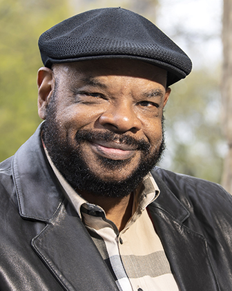 a man in a black hat and jacket