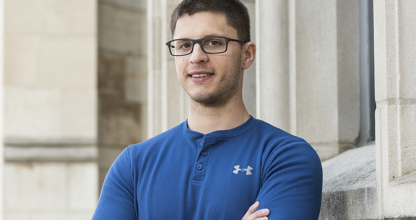 Matelan in a blue shirt and glasses