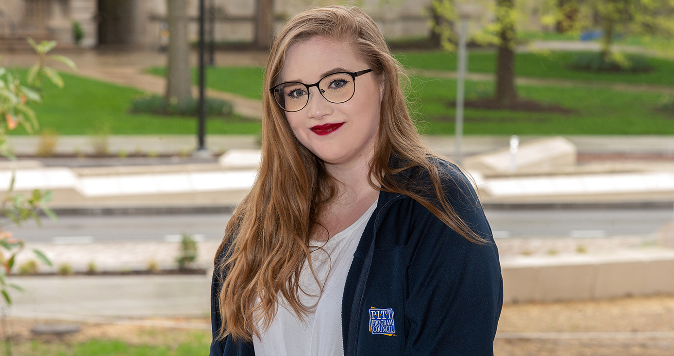 Quincy Johnston in a blue Pitt jacket and a white top