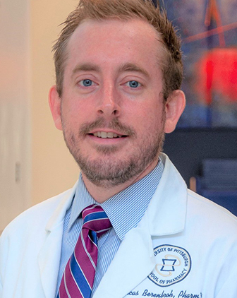 Lucas Berenbrok in a white coat and red striped tie