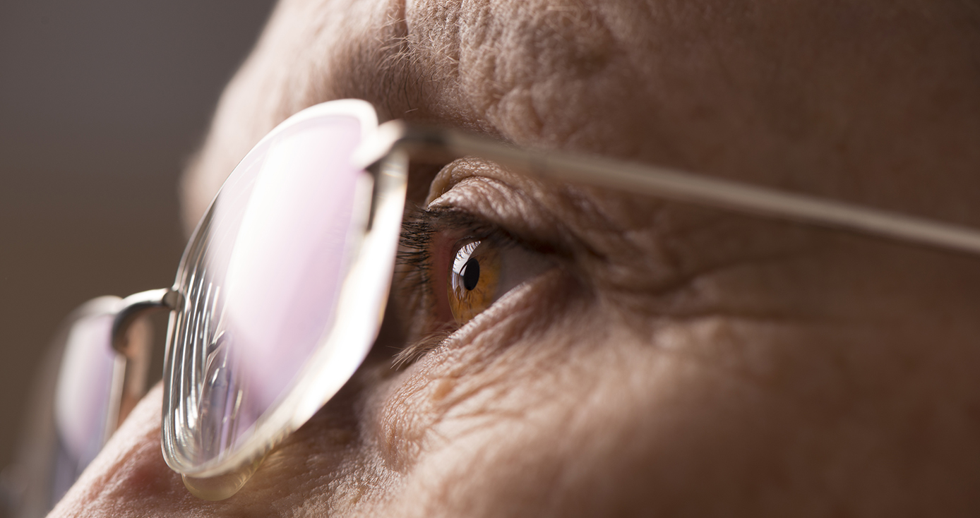 A closeup of glasses and an eye