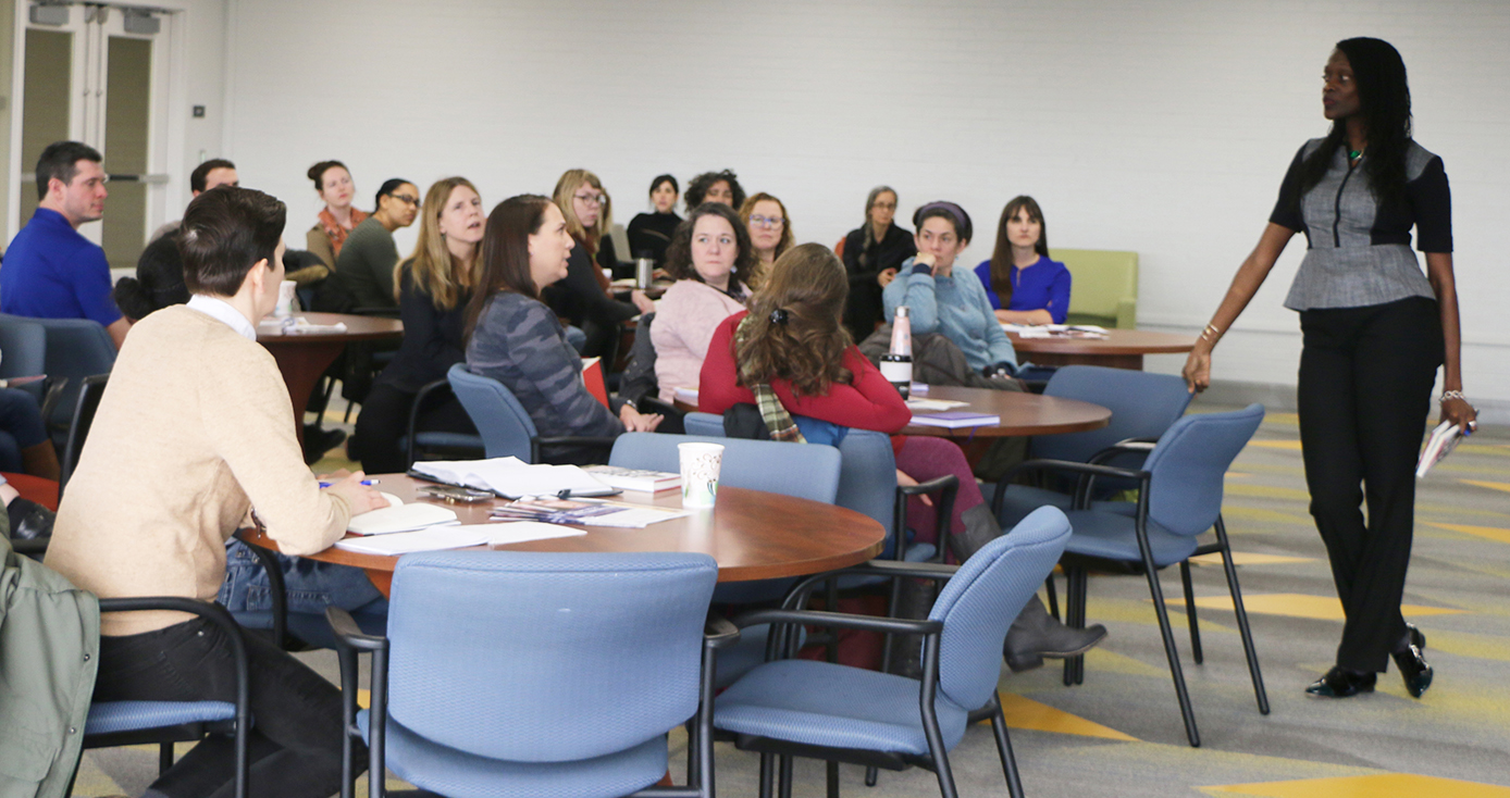 Valerie Kinloch stands before a group of people gathered for a book discussion