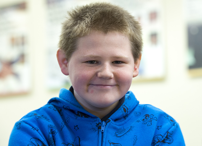 young boy in a blue hoodie