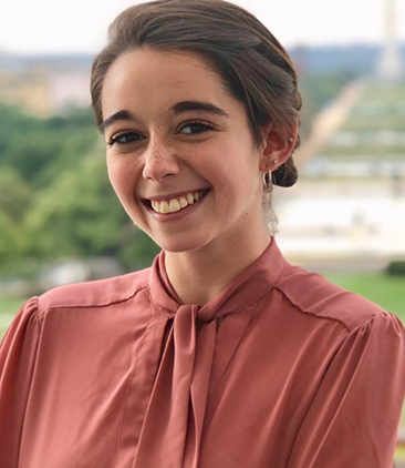 A woman in a light red shirt 