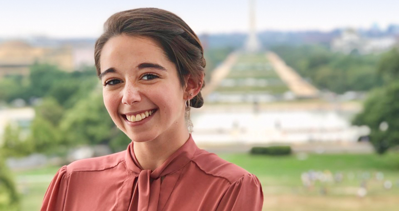 Fleisher in a rose top, with the Washington Monument deep in the background of the photo