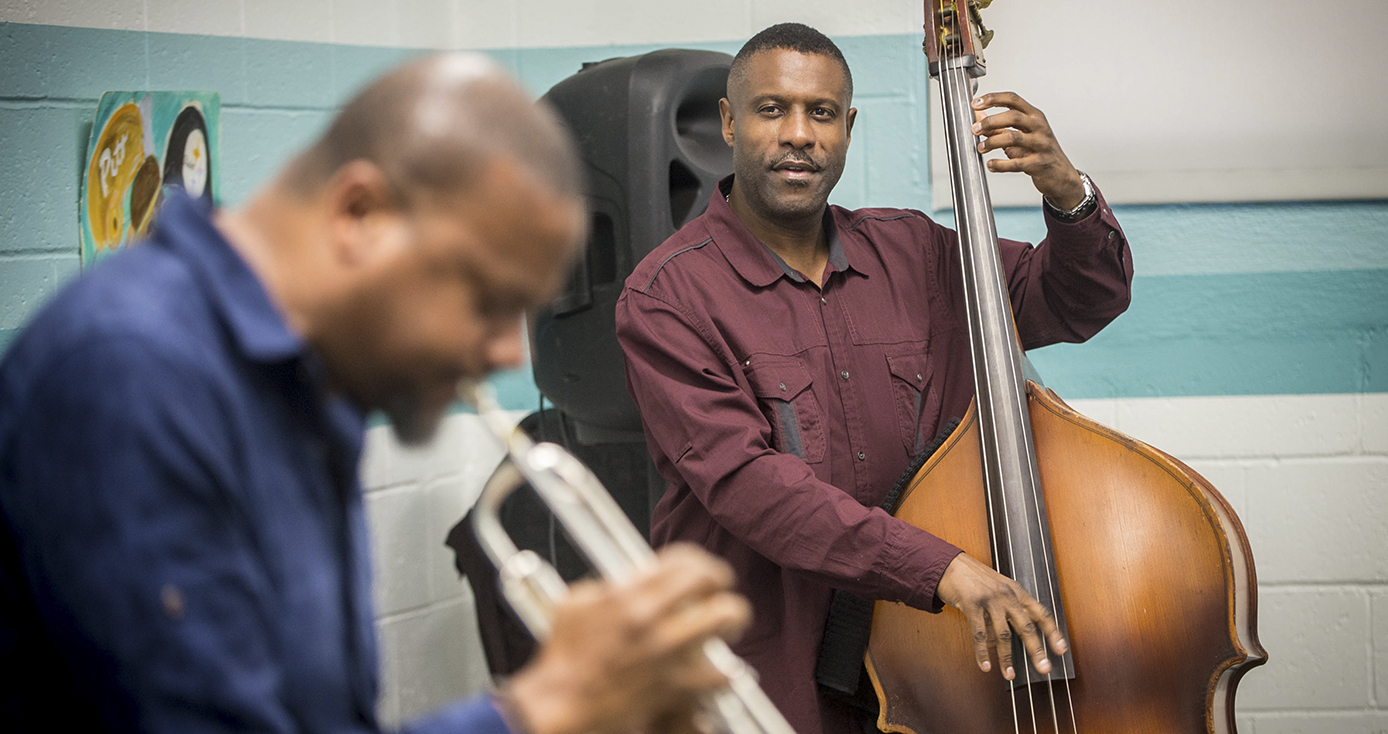 man playing a trumpet and another playing a standup bass