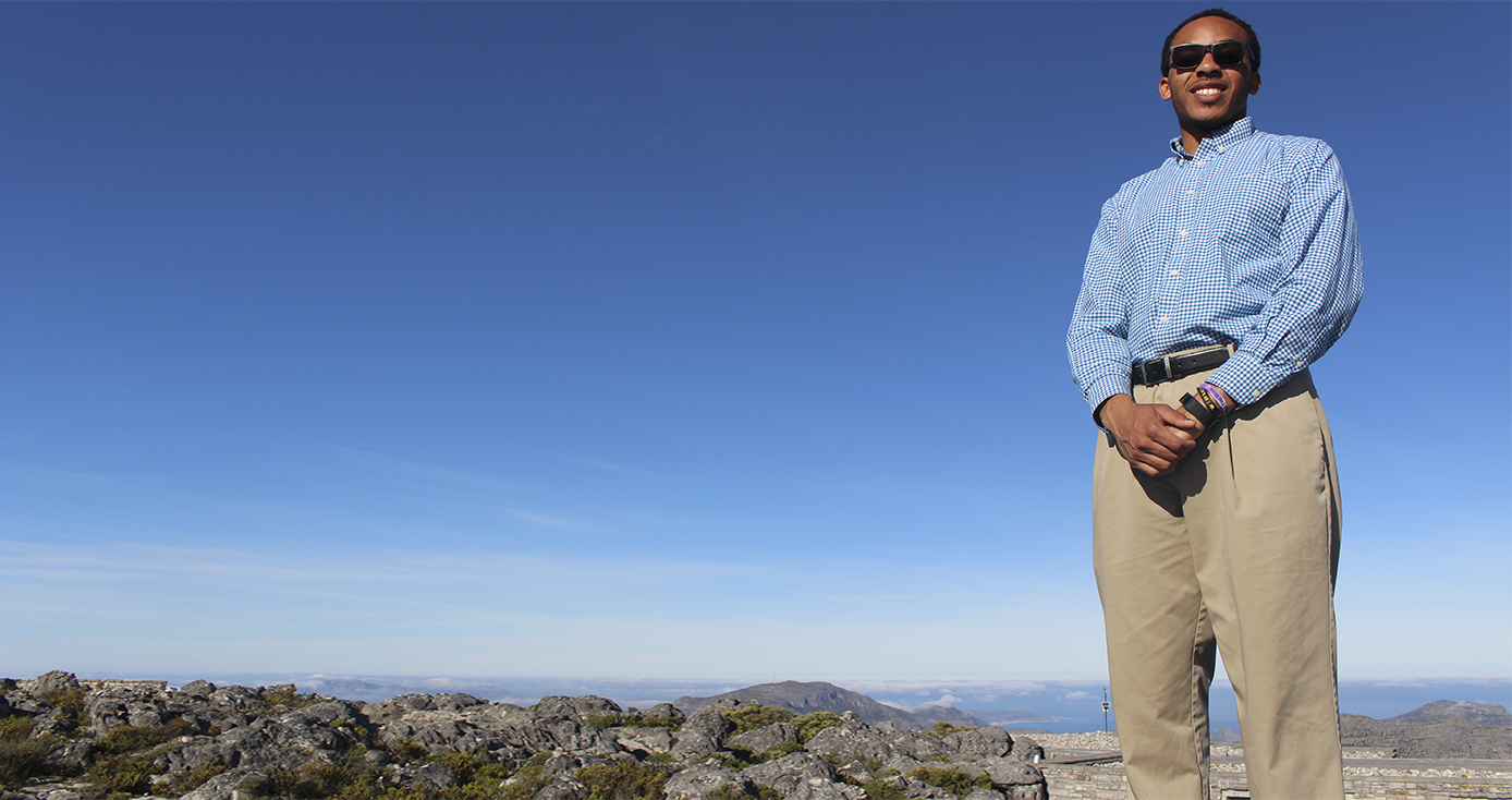 Isreal Williams posing in front of a mountain landscape