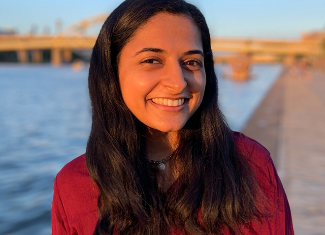 a woman in a red shirt smiling