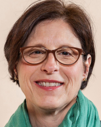 A woman in glasses and a green scarf