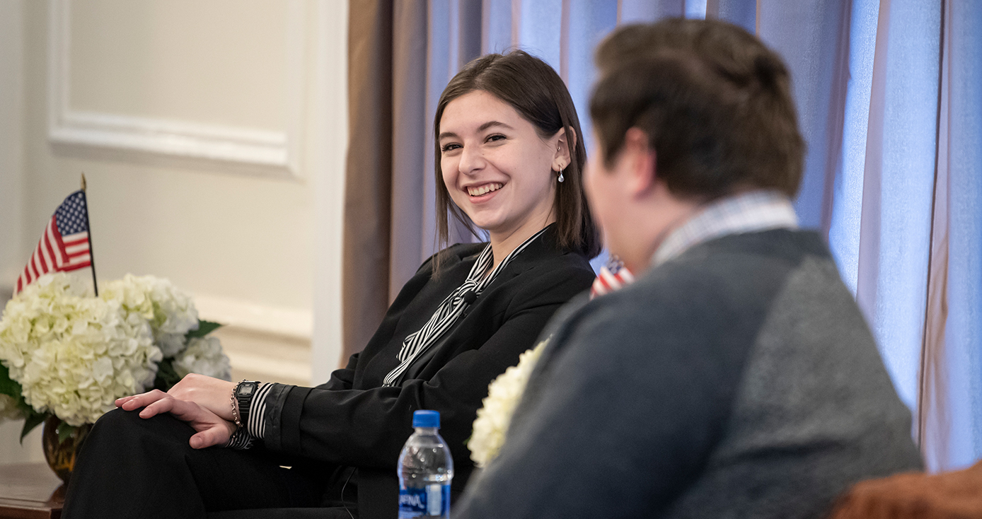 Lauren Ban talking with a panelist in a dark jacket