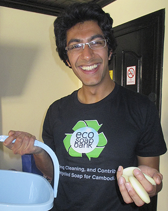 Samir holding a bucket of soap