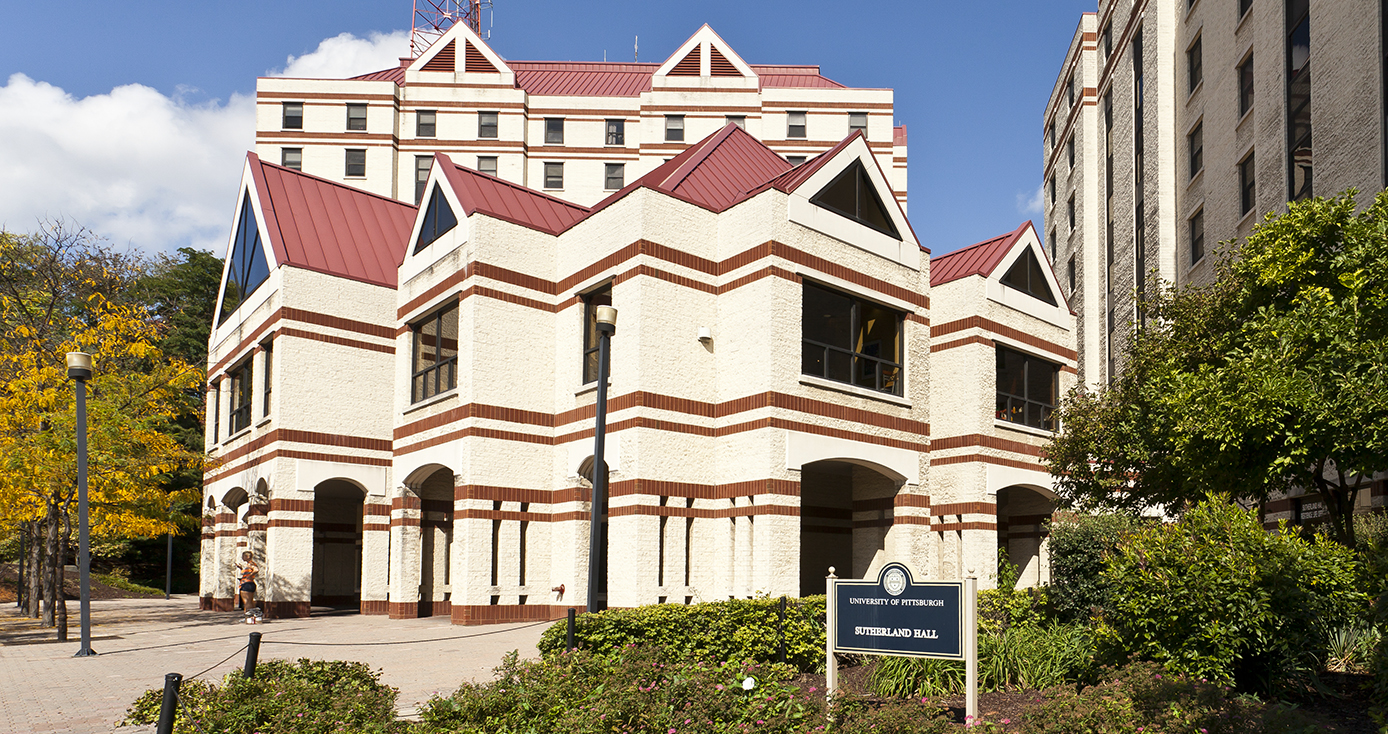 photo of Sutherland Hall, a white and maroon building in upper campus