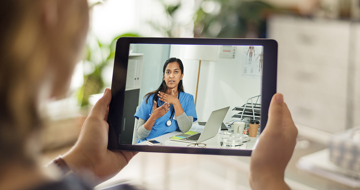 A physician administers a telehealth checkup with a patient virtually