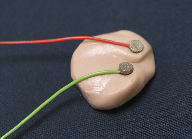 an earbud with wires attached to it