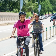 
Woman riding bike in a Pitt shirt
