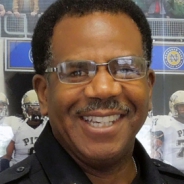 A man in glasses and a police uniform