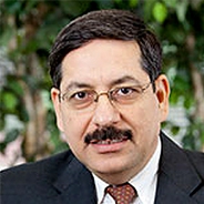 
Prakash Mirchandani in a black suit and white shirt
