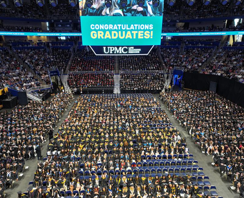 Crowd of seated students at Pitt commencement