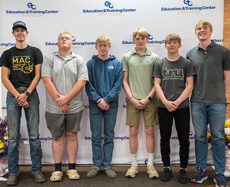 Titusville students standing in front of a screen reading Education & Training Center
