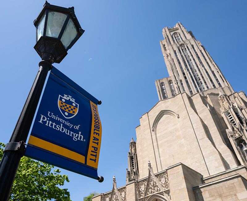 Cathedral of Learning with lamp sign that reads "University of Pittsburgh: It's Possible at Pitt"