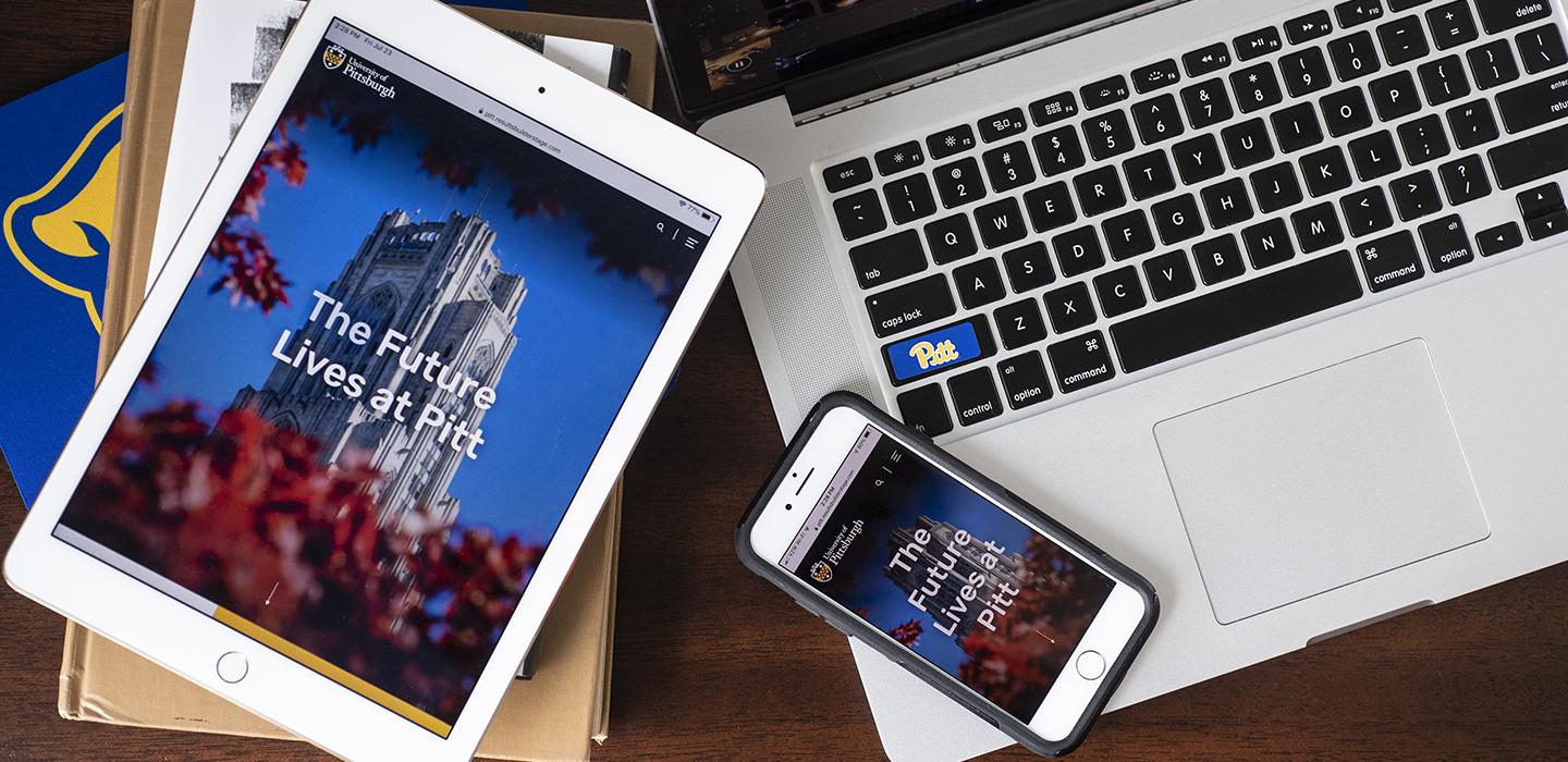 a laptop, tablet and phone with the new pitt.edu website pulled up