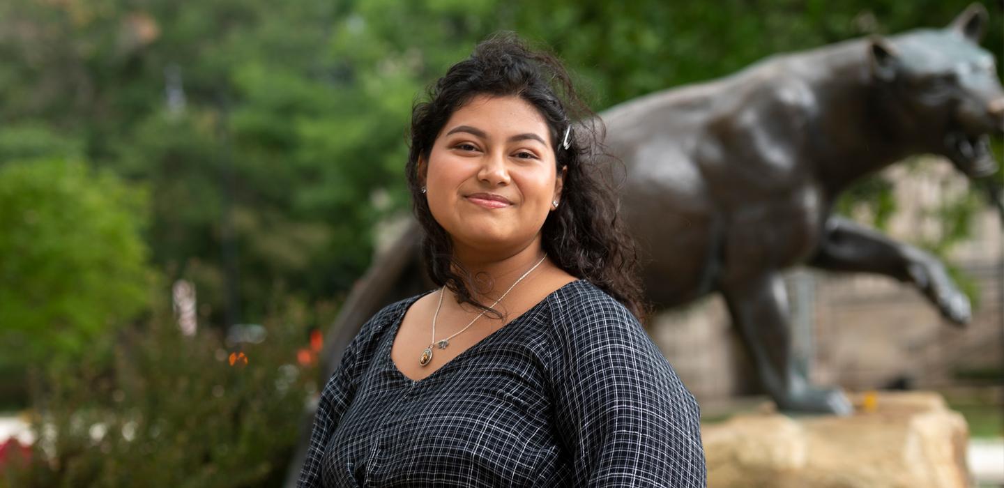 Jennifer Espinoza wearing black shirt with panther statue in background