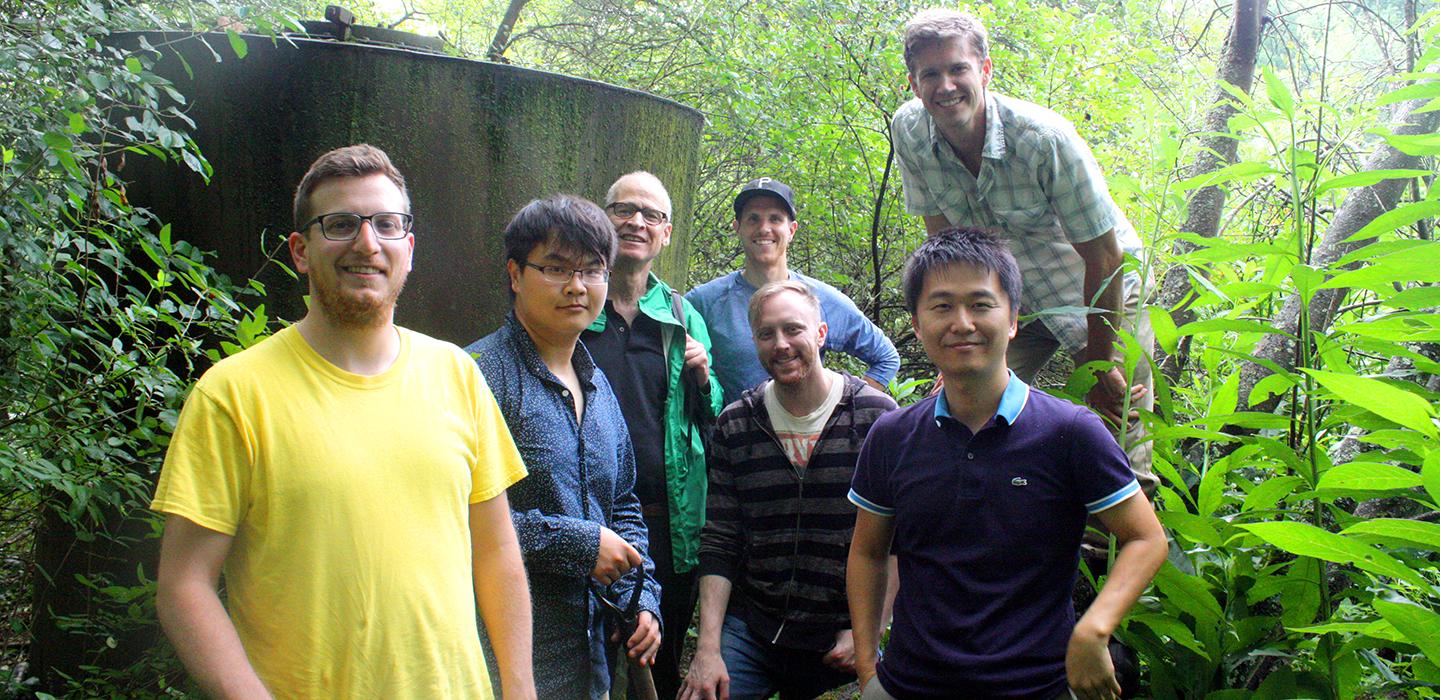 GSPIA students grouped together, smiling in the woods 