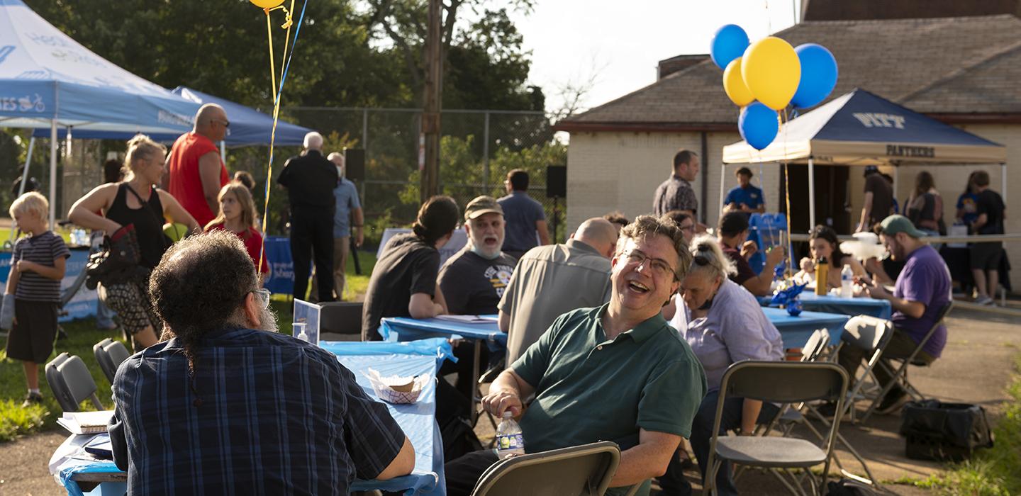 Oakland block party, decorated with gold and blue balloons