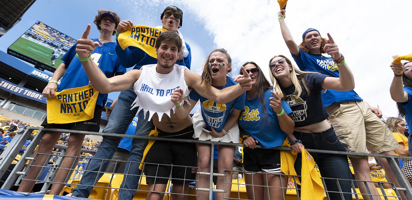 Pitt fans cheering with yellow Panther Nation towels