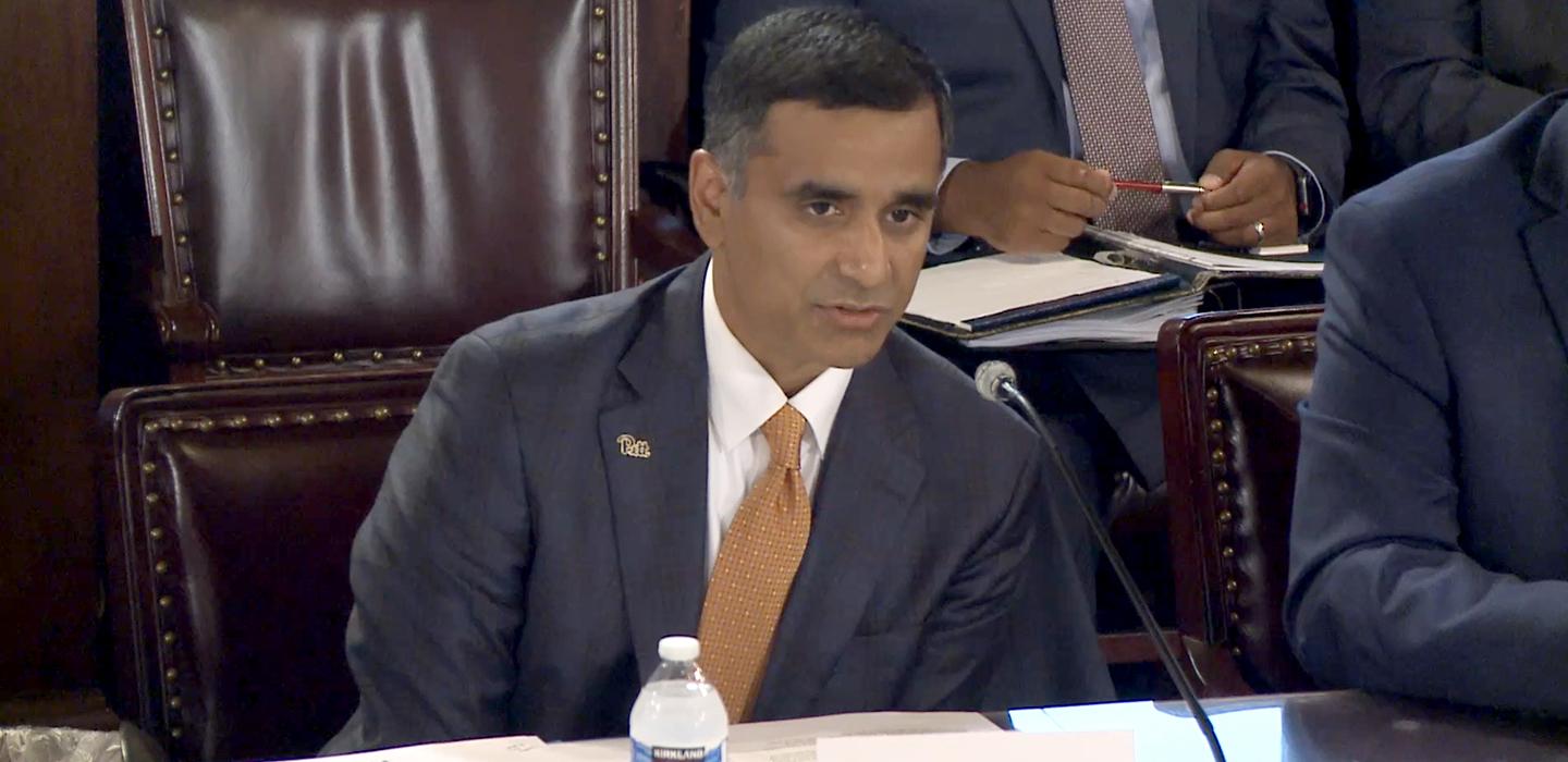 Hari Sastry speaking into microphone during testimony