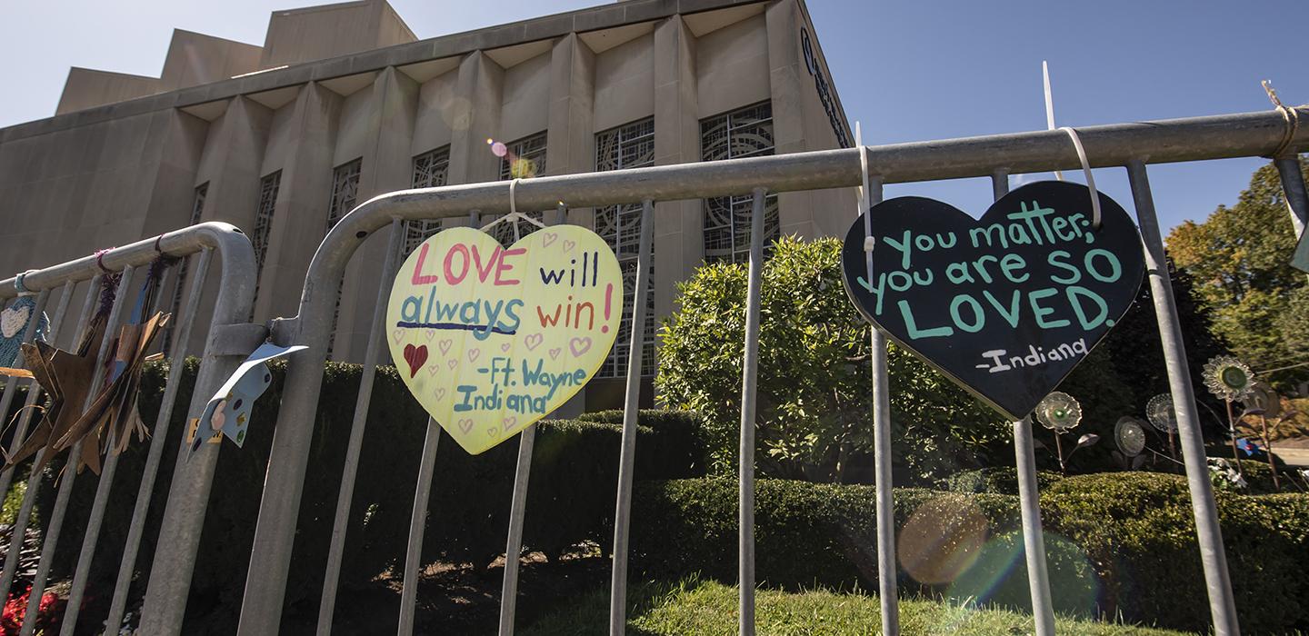 Heart-shaped signs attached to fence