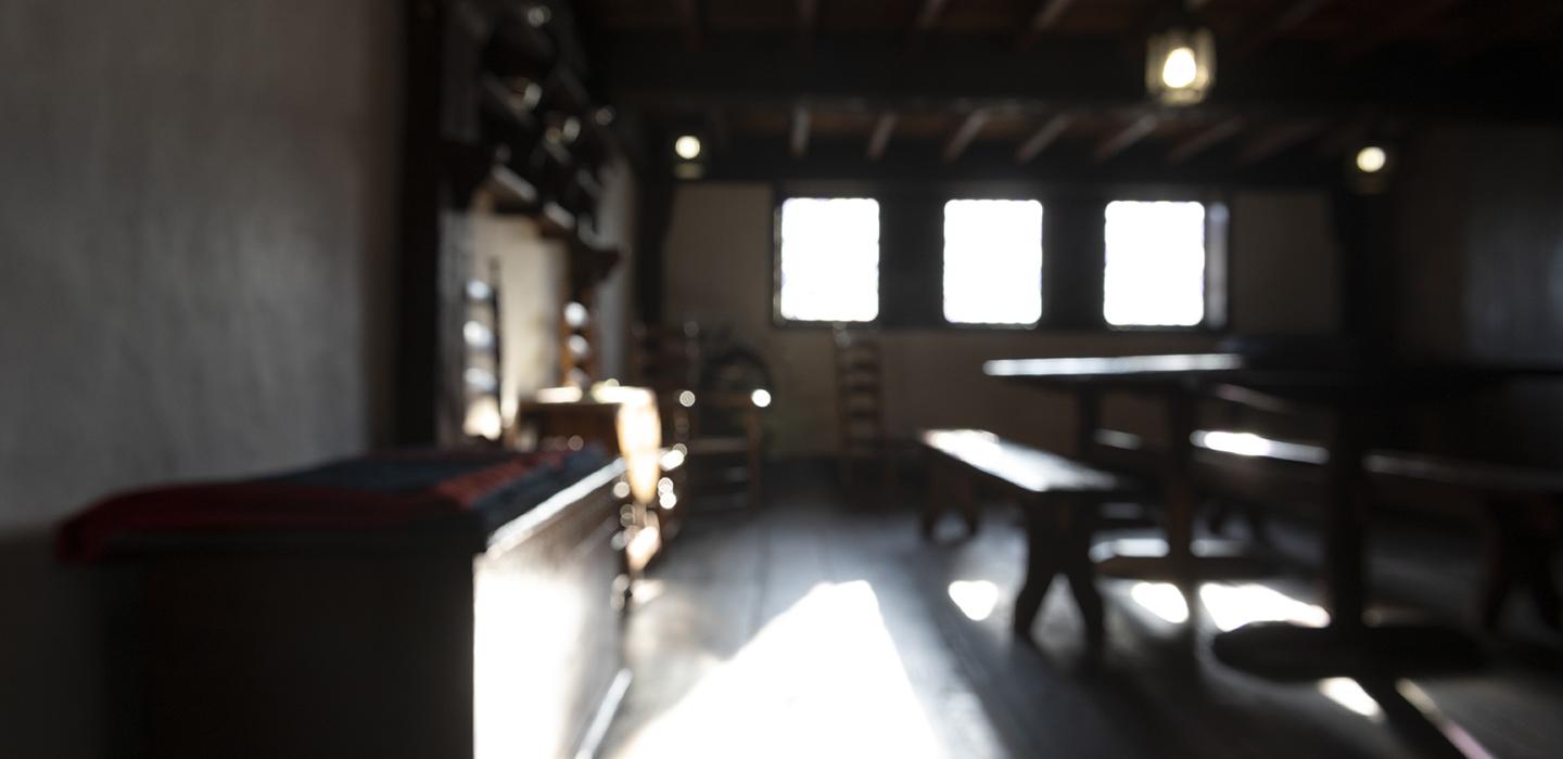 Dark room with wooden floors and furniture 