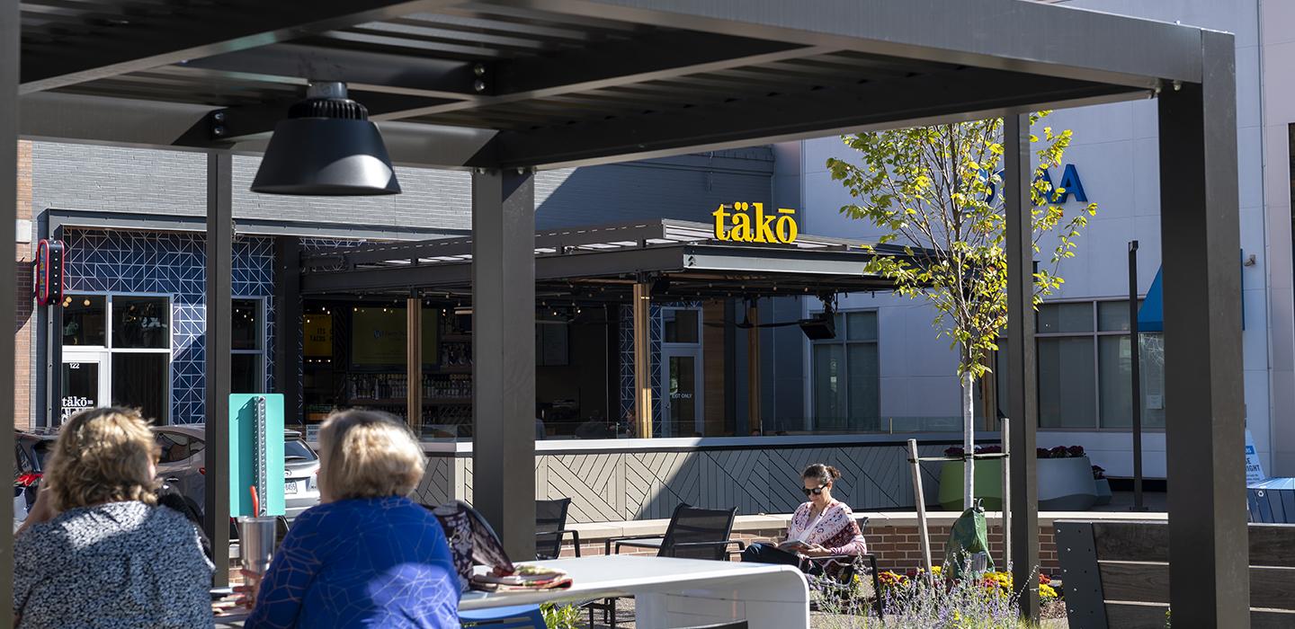 People sitting outside of Tako restaurant in Bakery Square