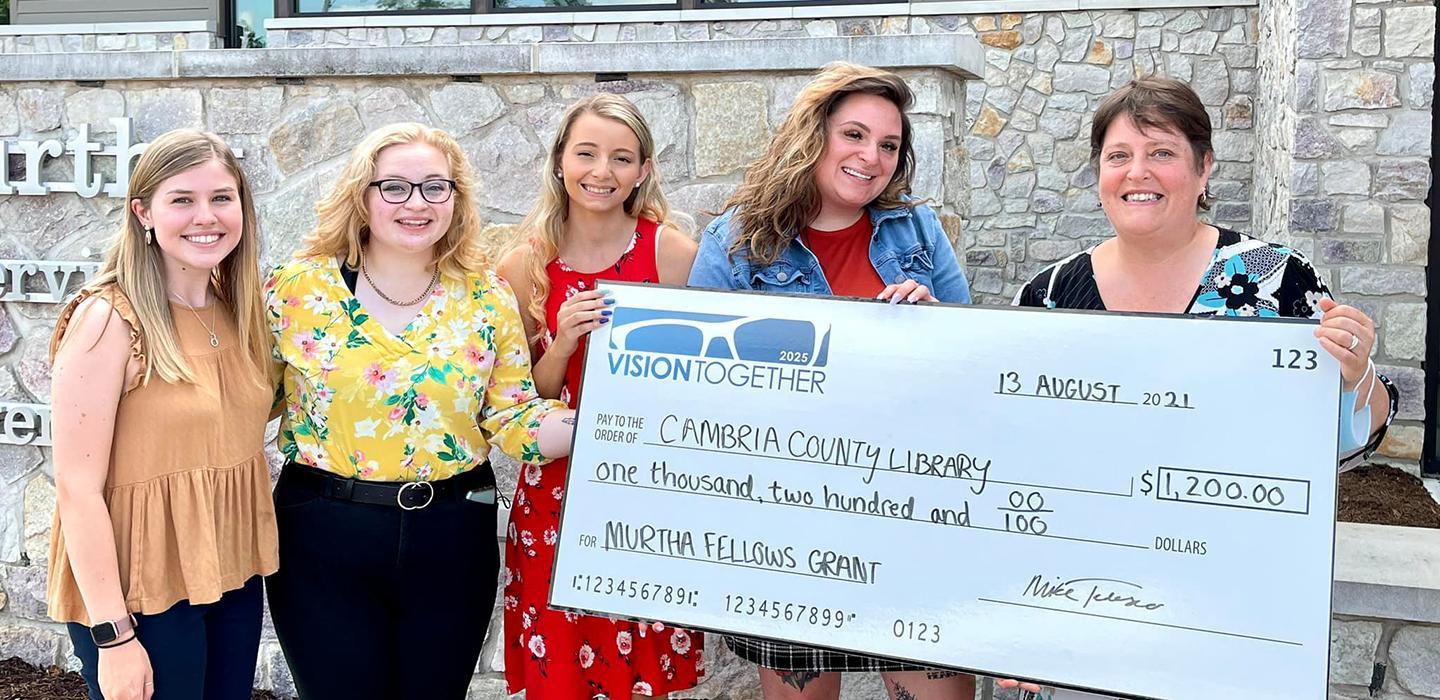 Johnstown group holding large check from Cambria County Library