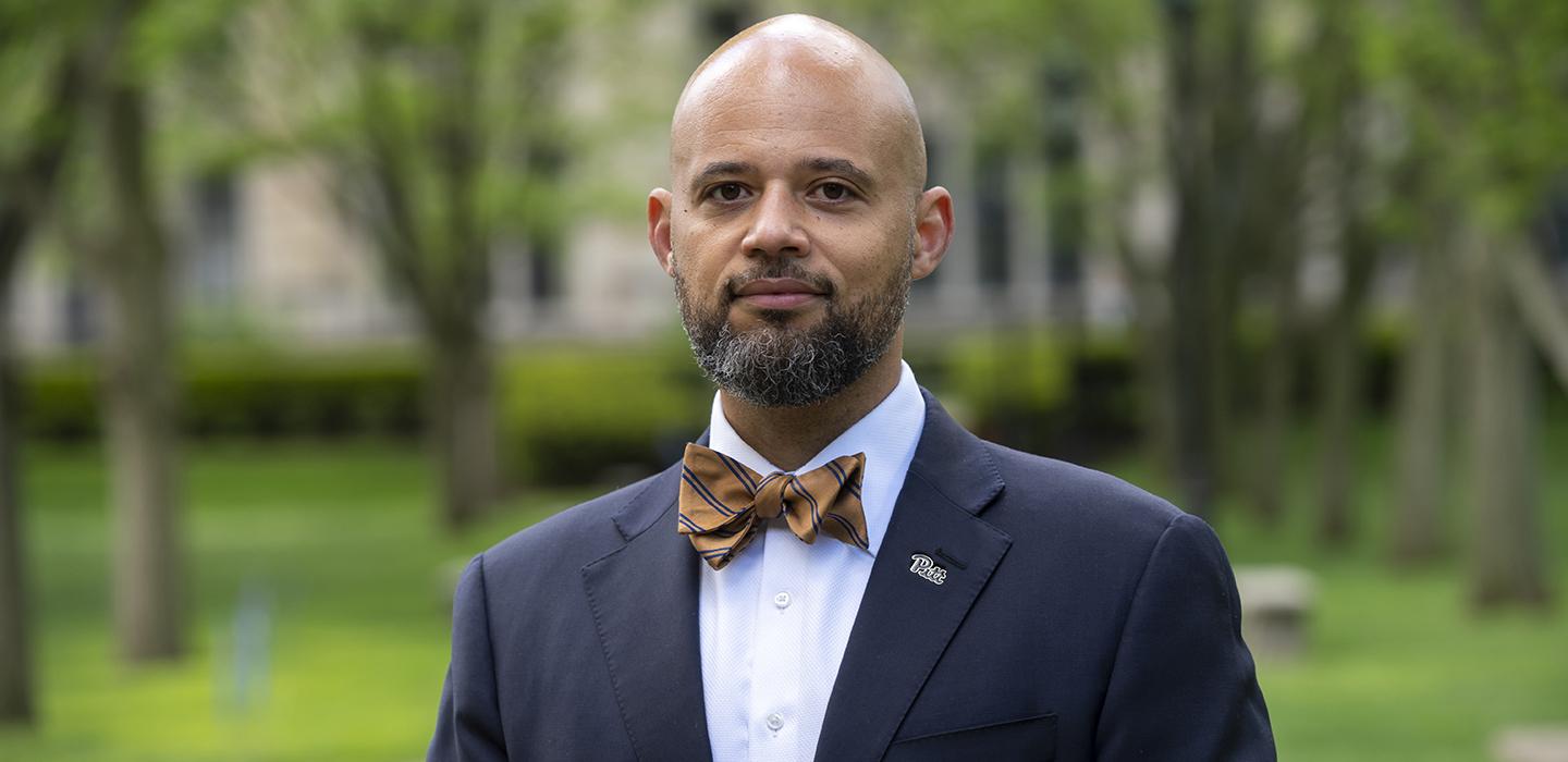 Clyde Pickett wearing suit and brown bowtie 