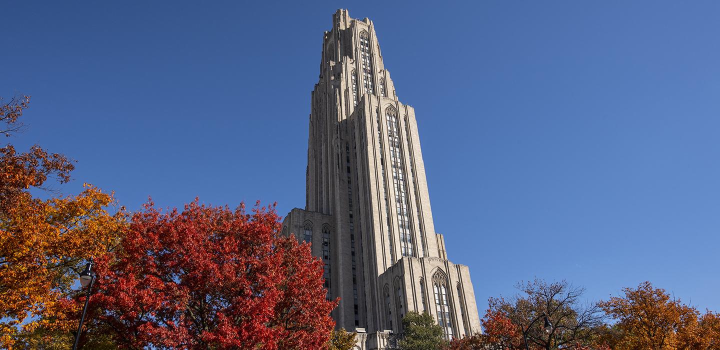 Cathedral of Learning behind trees during Fall
