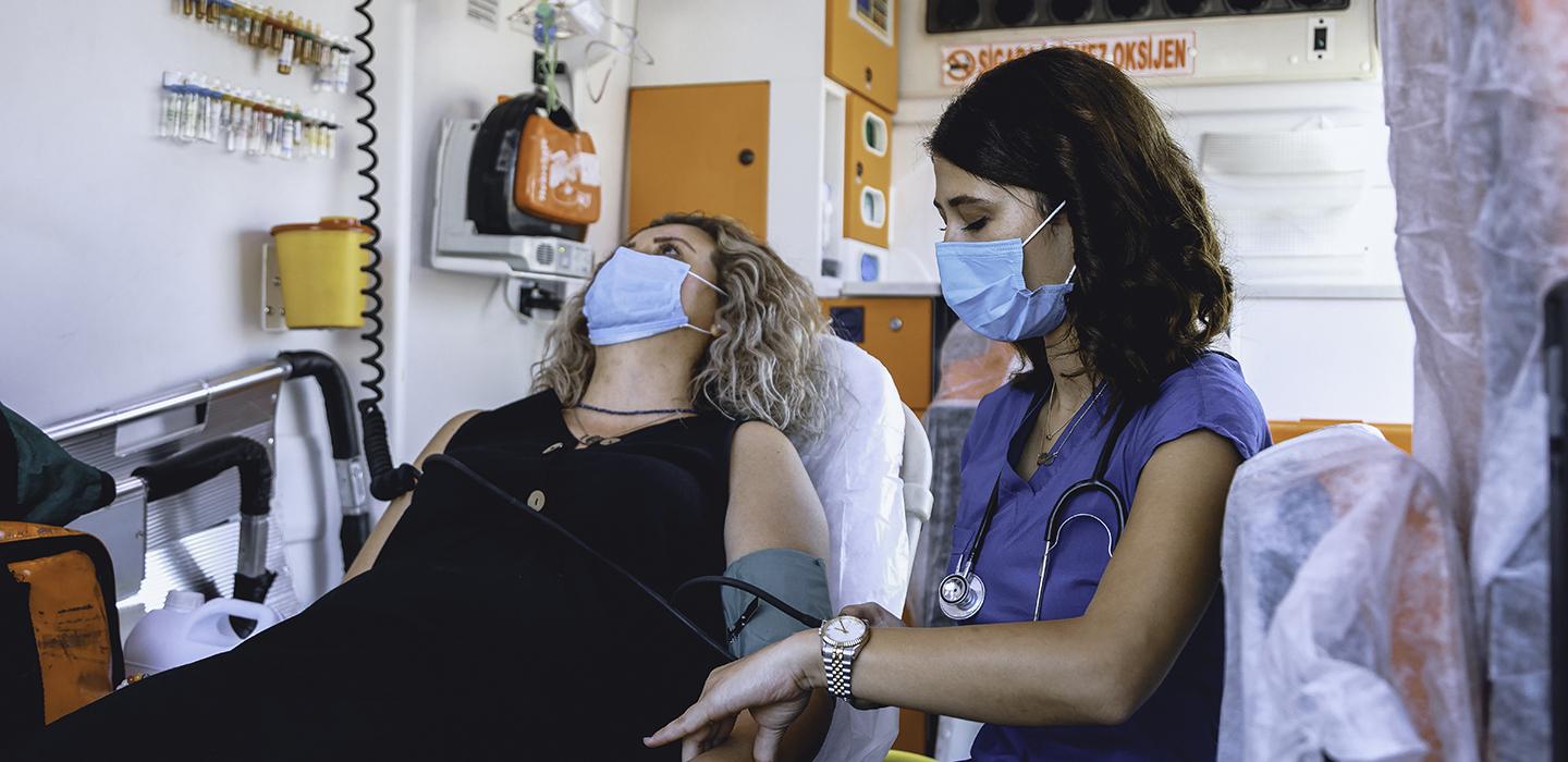 a nurse tending to a prone patient in an ambulance