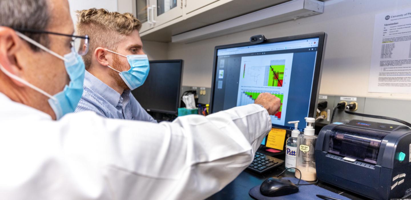 Alexander Sundermann and Lee Harrison working in lab