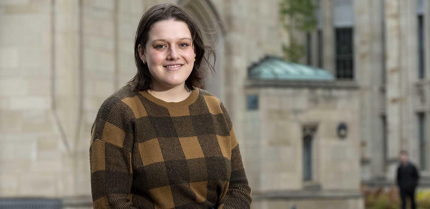 Maja Lynn wearing brown plaid sweater on Pitt campus