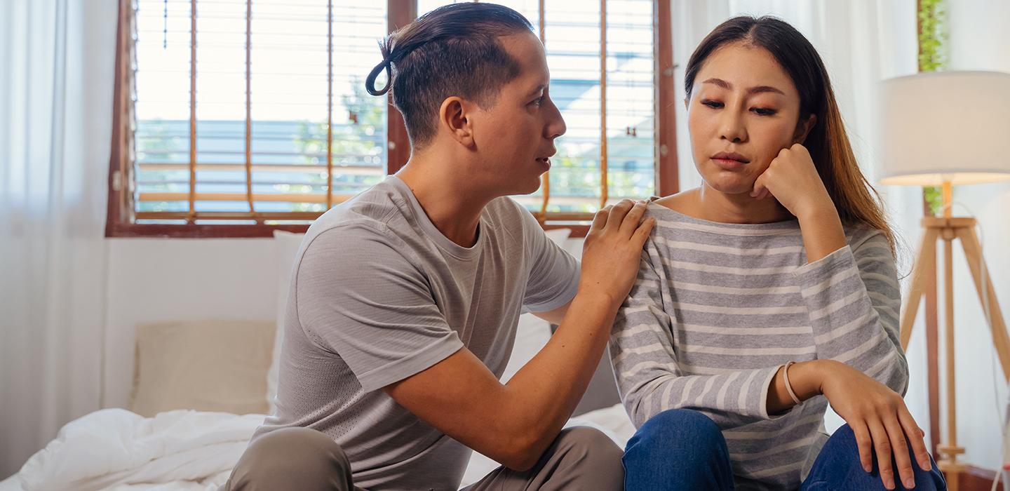 Man comforting a woman during a difficult conversation