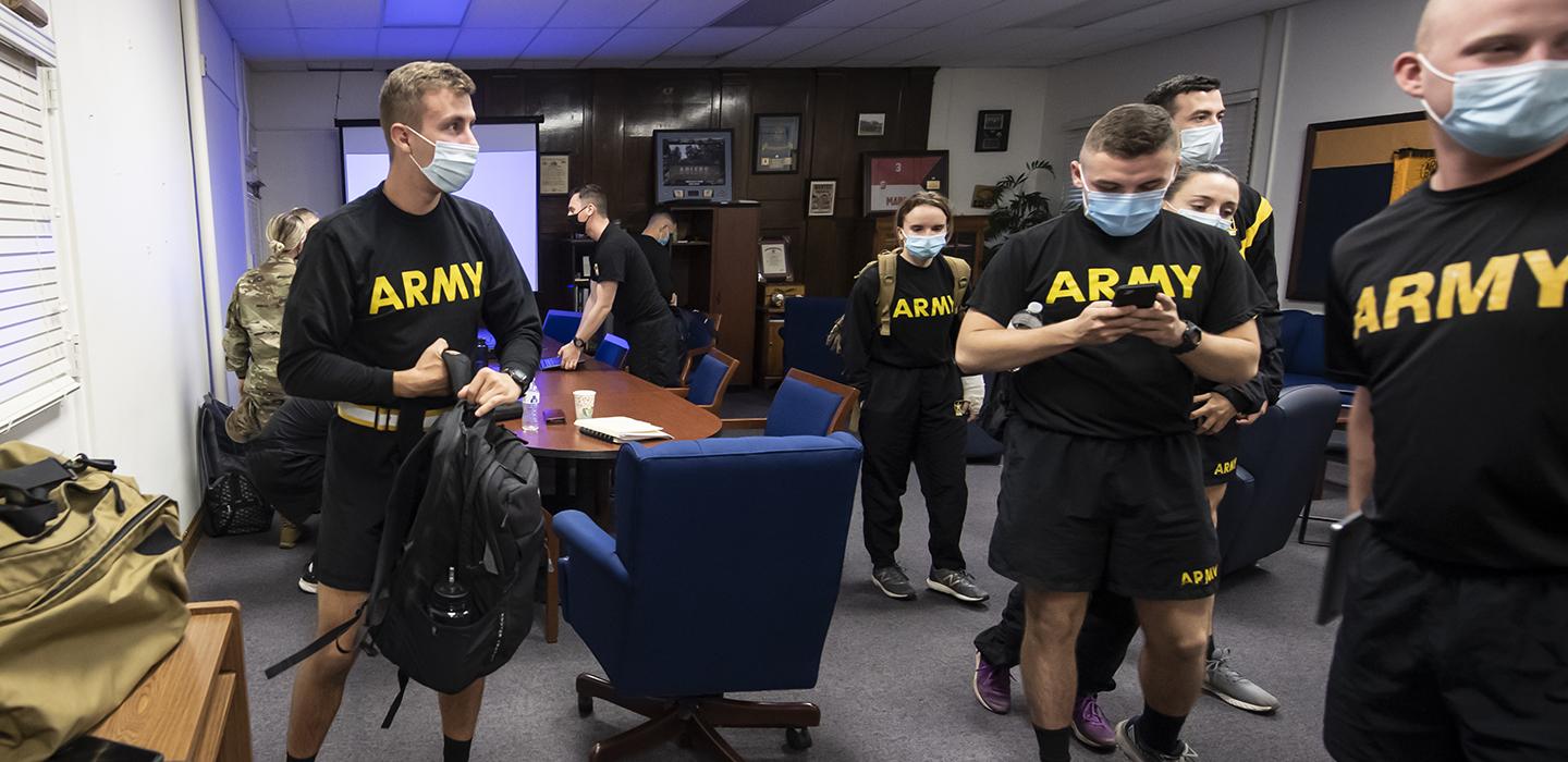 Matthew Starinsky and team wearing black Army shirts and face masks indoors